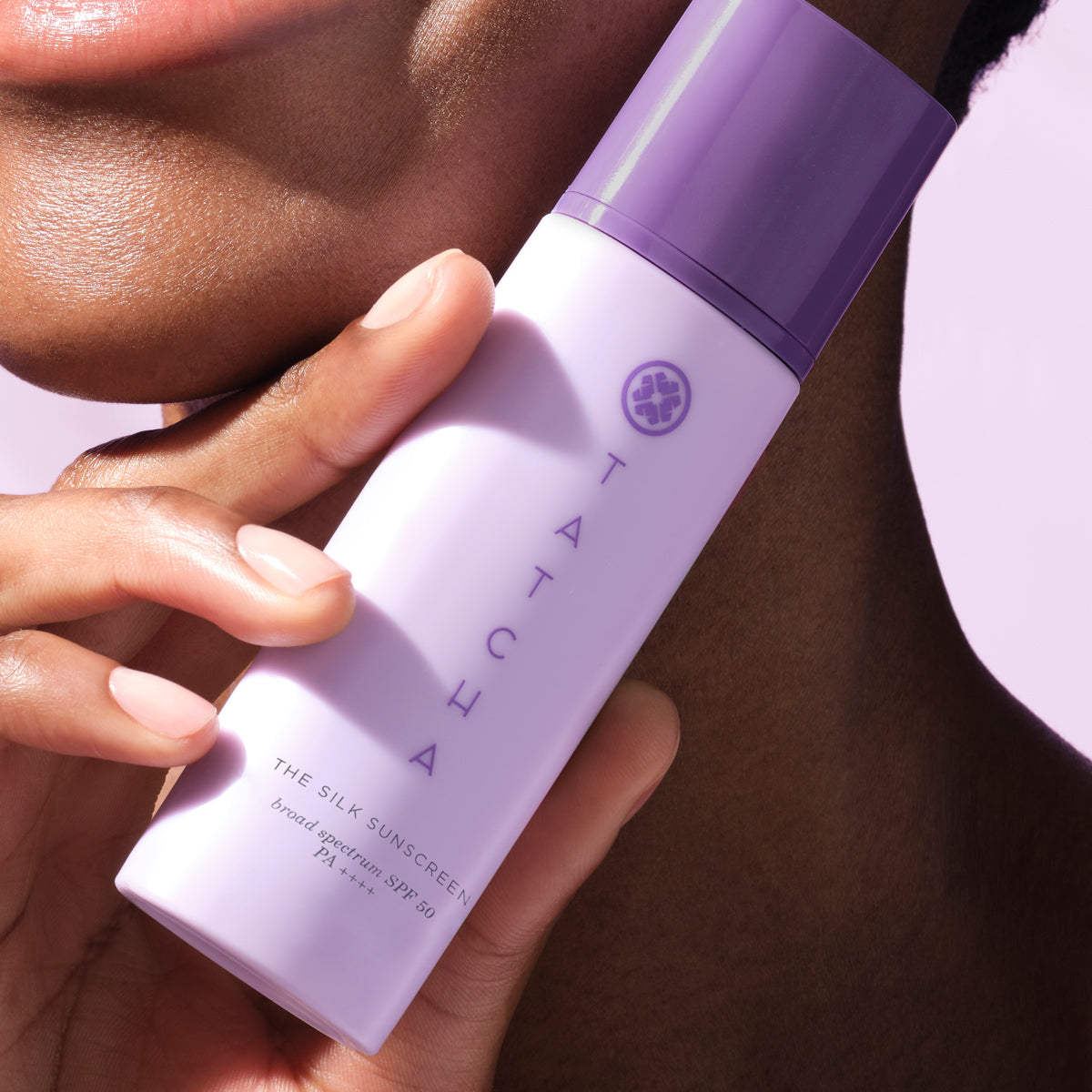 Model holding The Silk Sunscreen