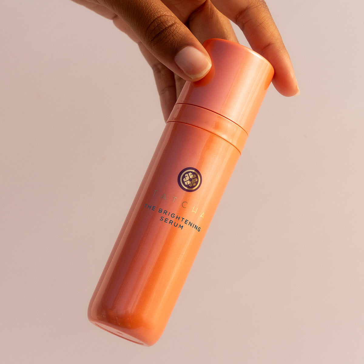 Hand holding the Brightening Serum
