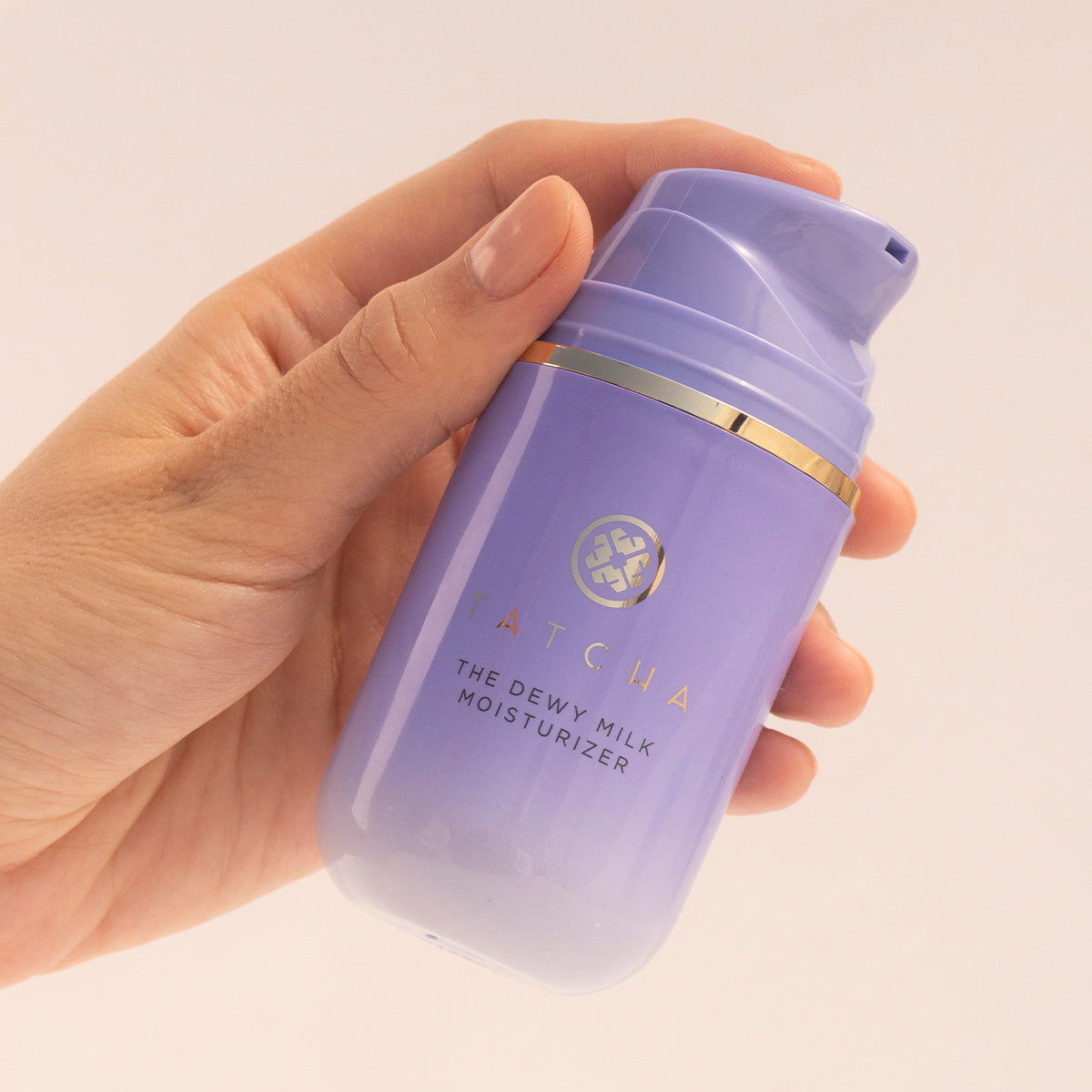 Hand holding Dewy Milk Moisturizer