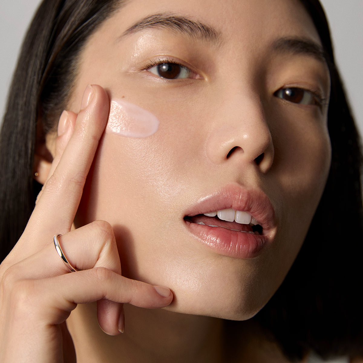 Model application showcasing the Tatcha Dewy Milk Moisturizer