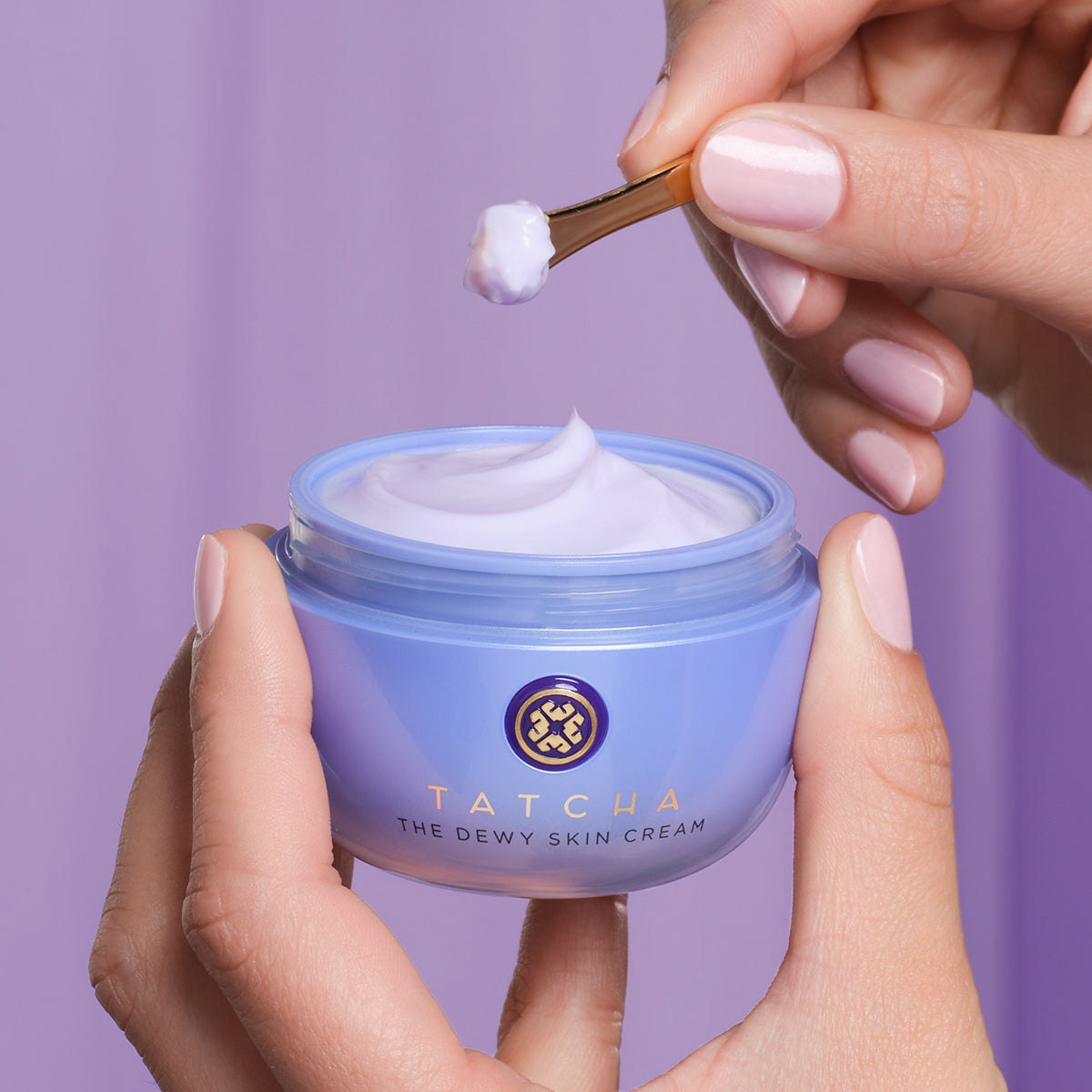 hand scooping The Dewy Skin Cream