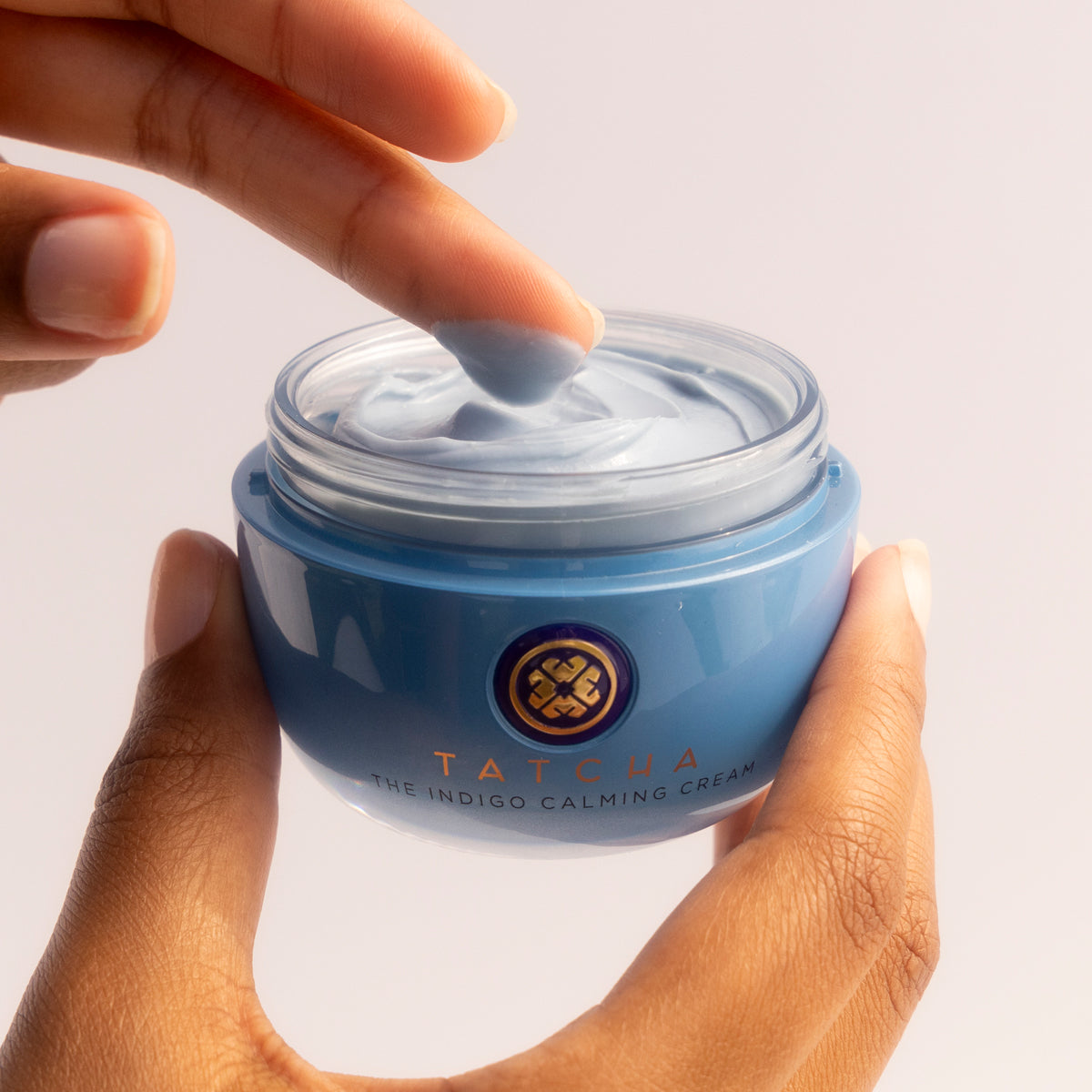Finger dipping into Indigo Calming Cream