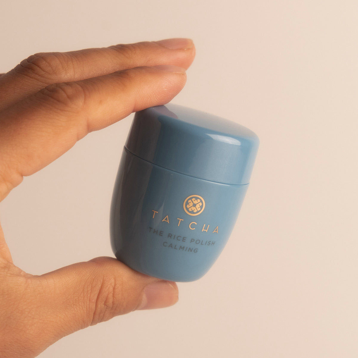 Hand holding Rice Polish Calming Mini