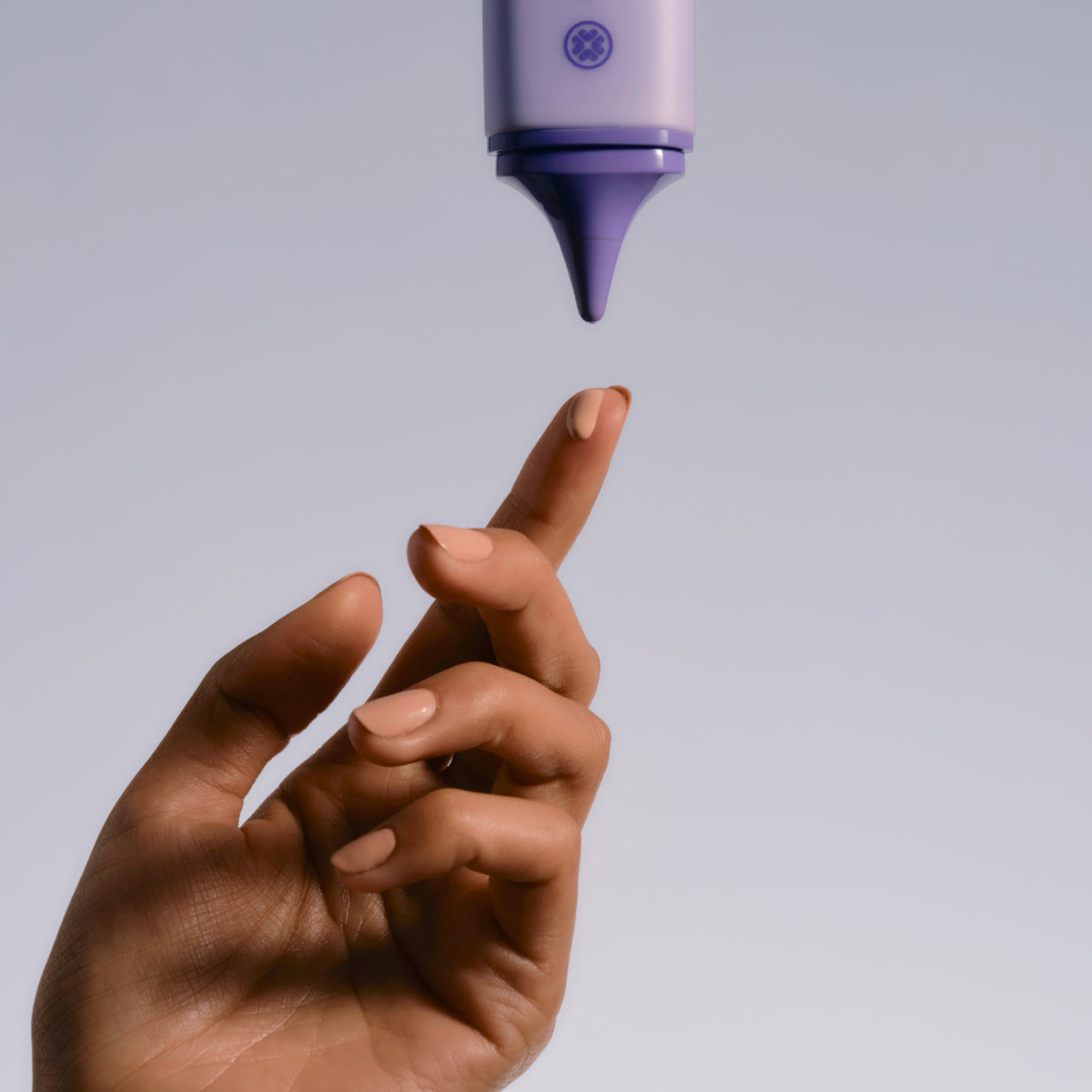 Hand catching the Tatcha Silk Sunscreen droplet swatch
